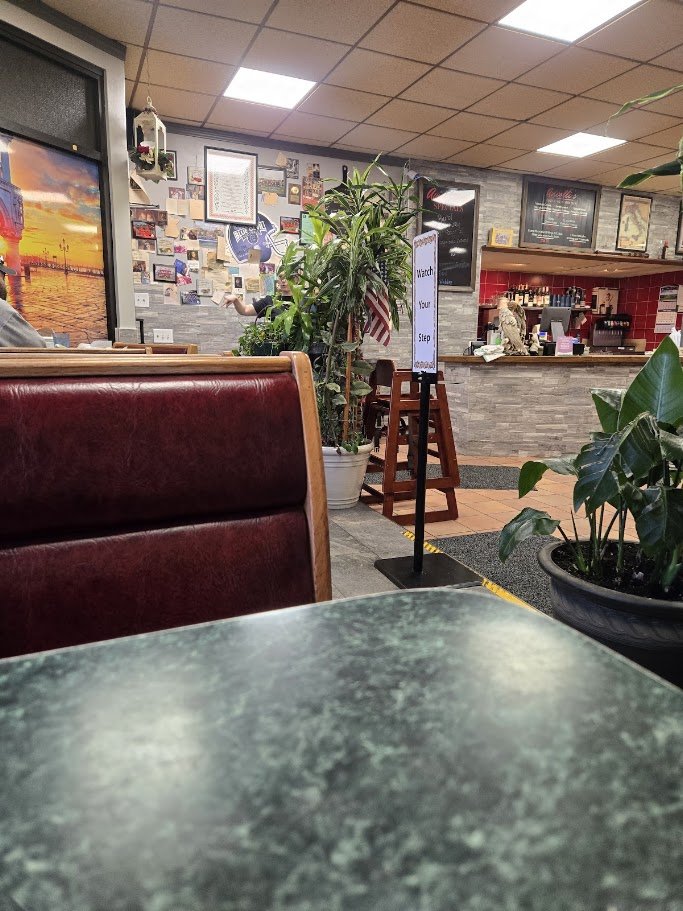Casual restaurant interior with simple tables.