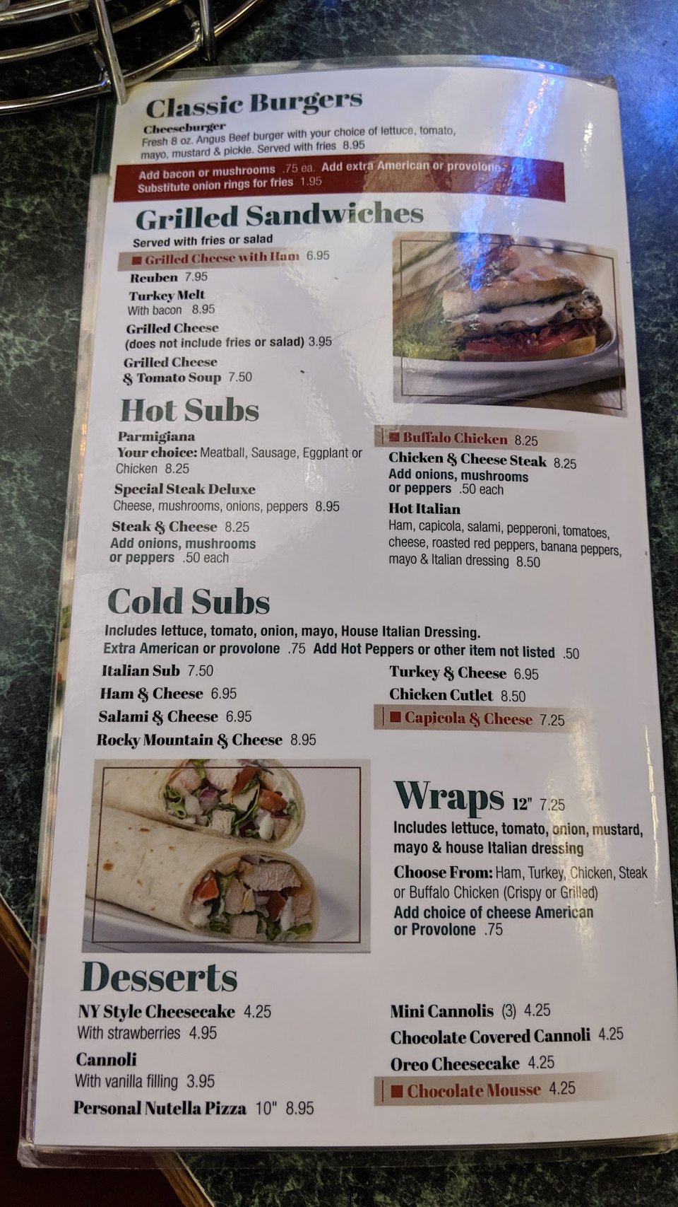 Menu board listing hot and cold subs.